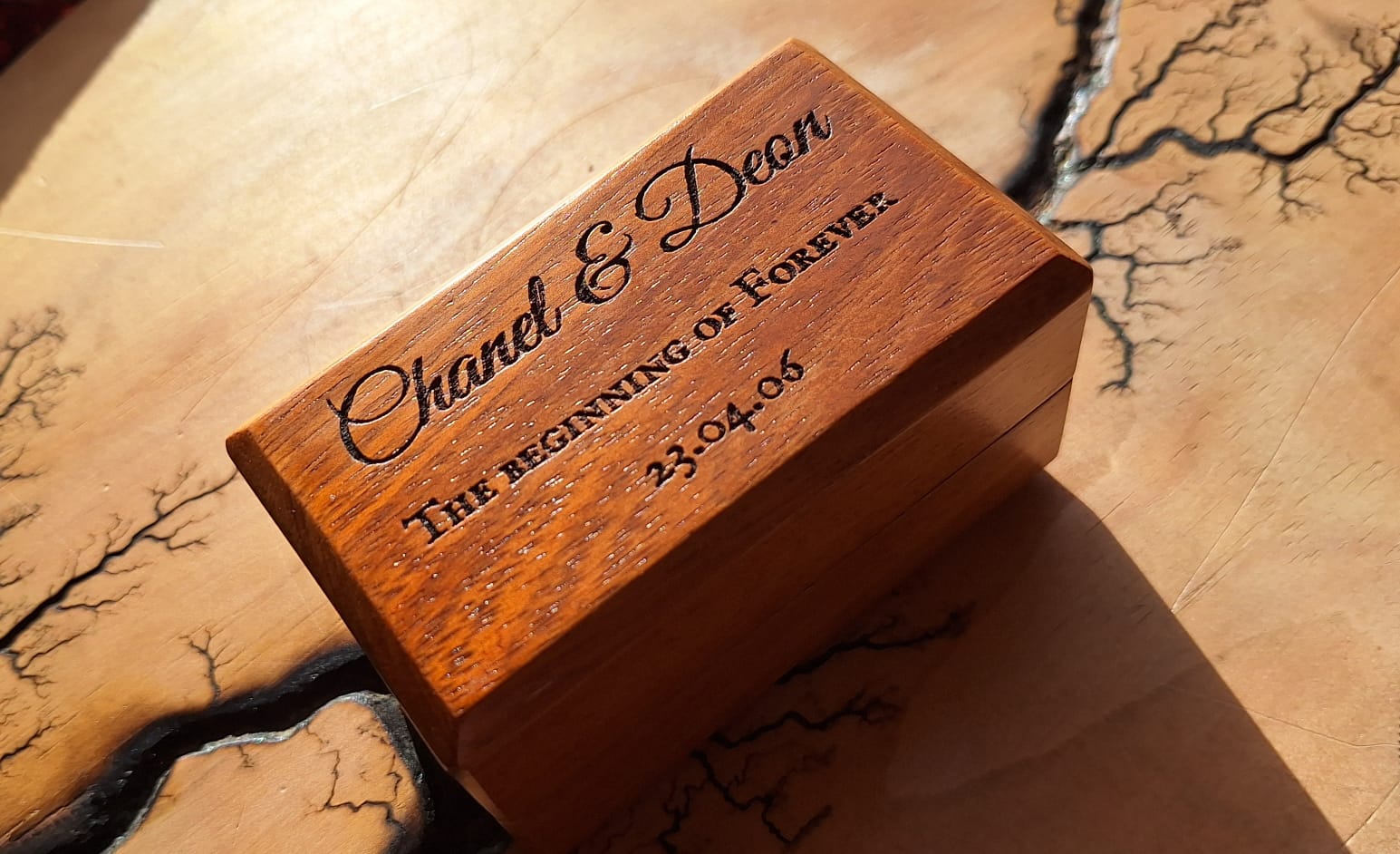 Handcrafted open wooden ring box holding two rings